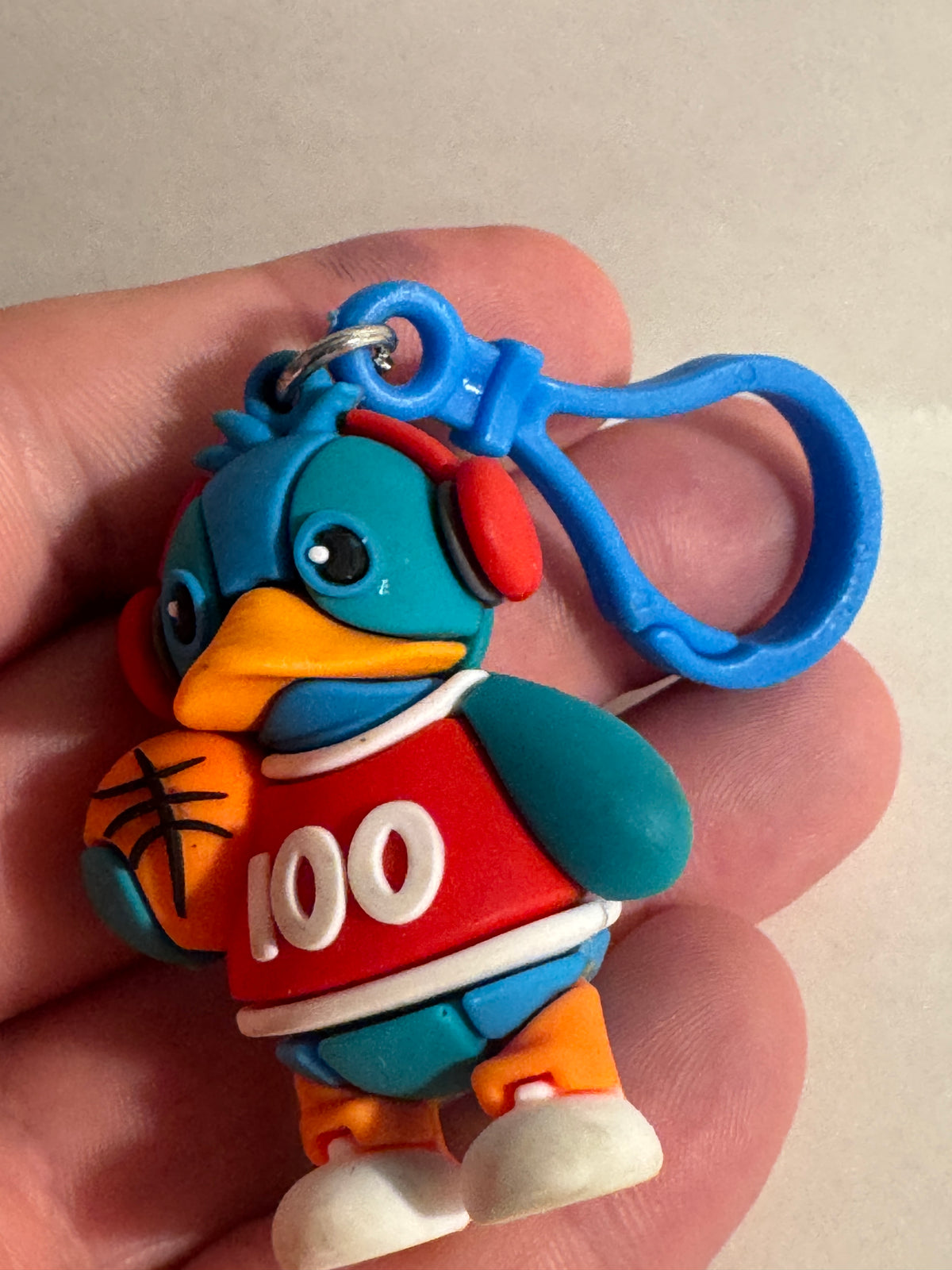 558 - Basketball Duck 100 Keychain Rubber Figure Blue Red Cute Clip On Backpack Charm