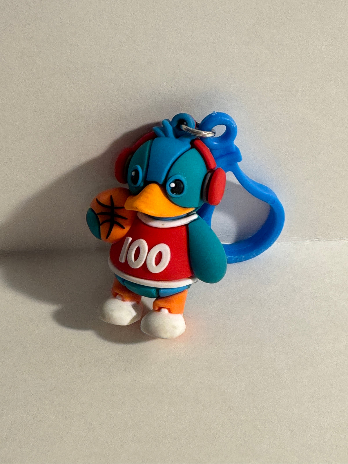 558 - Basketball Duck 100 Keychain Rubber Figure Blue Red Cute Clip On Backpack Charm